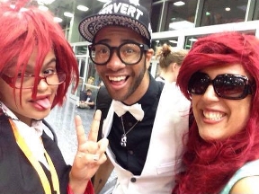 Mya at ACen 2015, cosplaying as Grell Sutcliff from Black Butler, with cosplay icons Panda & Lux